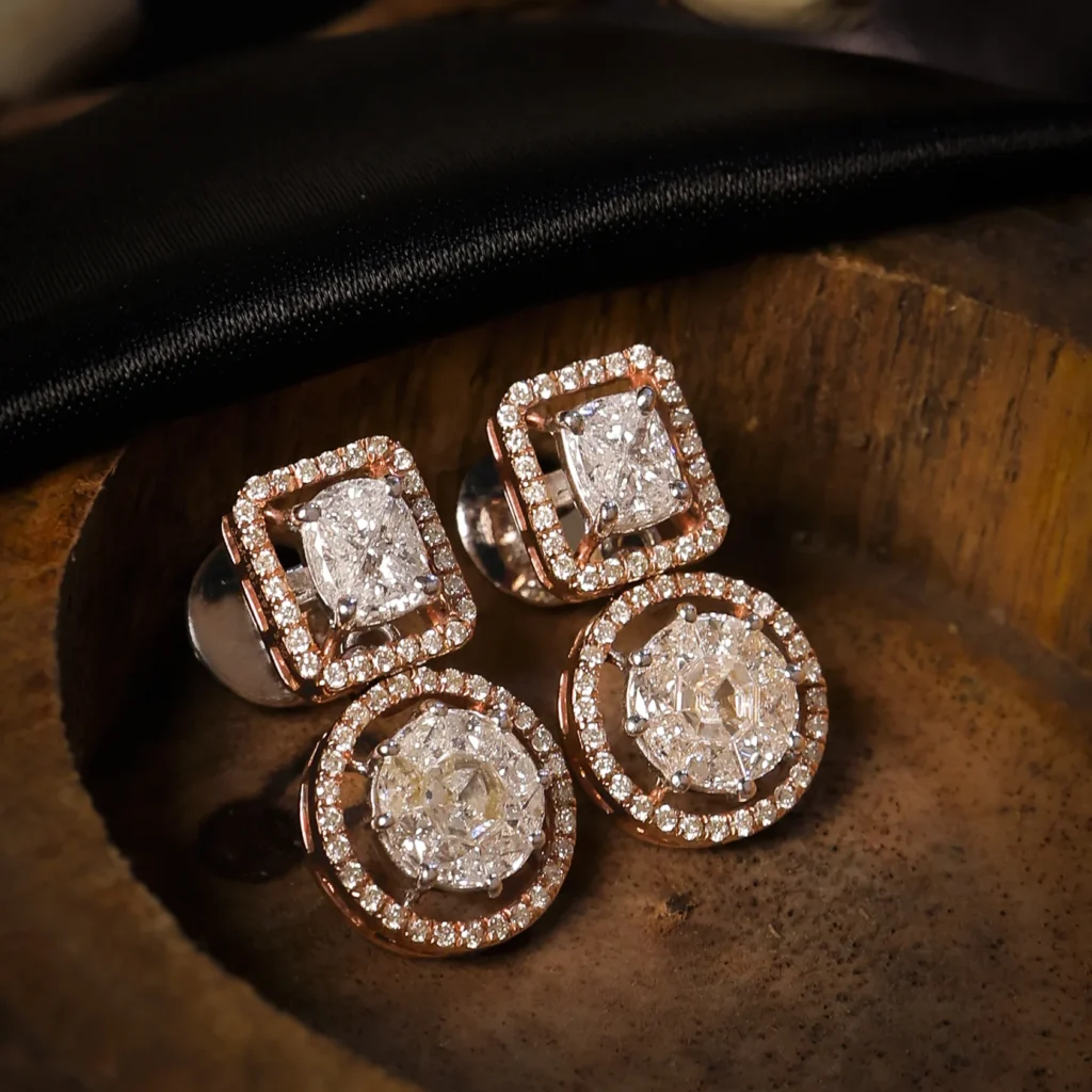 Diamond drop earrings on dark wooden surface