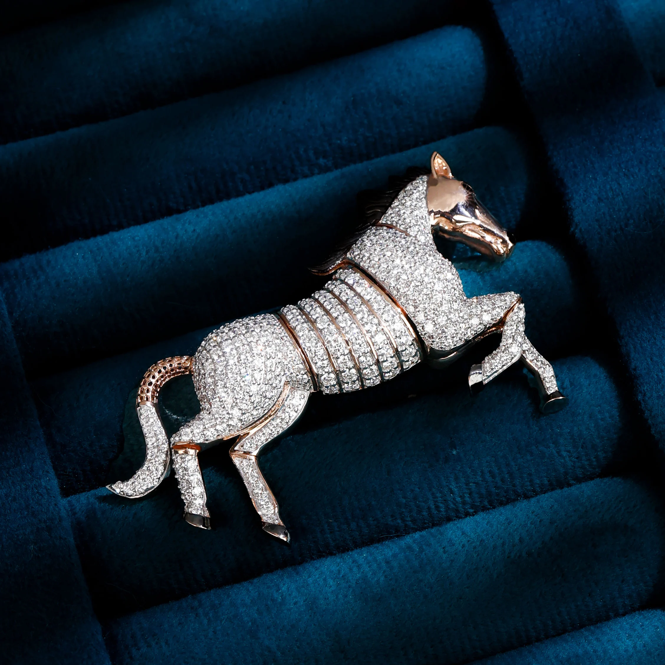 Diamond horse brooch on blue velvet