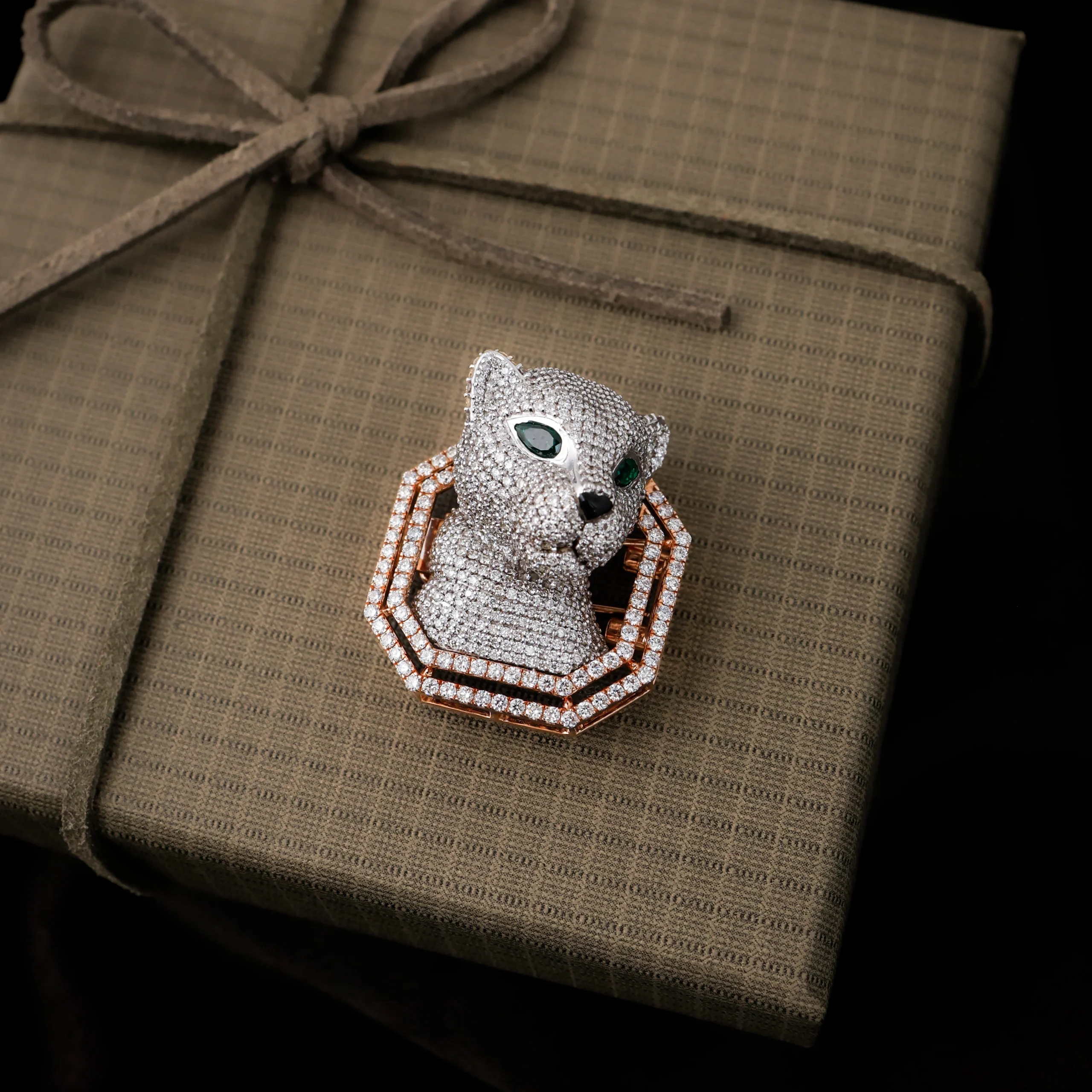 Diamond cat brooch on gift box background